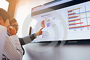 Close up two business people analysis chart working together at