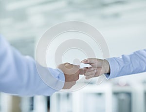 Close up of two businessmen exchanging business cards