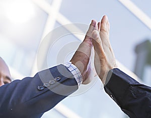 Close-up of two businessmen giving fist bump. Partnership concept