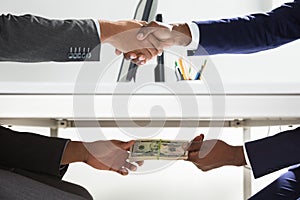 Two Businesspeople Shaking Hand And Taking Bribe