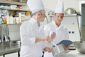 close up two chefs in kitchen