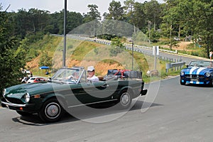 Close up Two classic italian sports cars on road