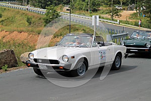 Close up Two classic italian sports cars on road