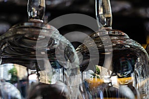 Close-up of two clean empty glasses above the bar counter. Interior of pub, bar or restaurant