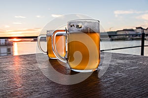 Two glass of beer on the brown wooden table, Slovakia