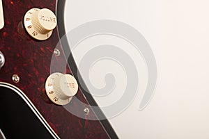 Close up of two conectors on  black electric guitar, studio shoot. Red tortoise shell pickguard photo