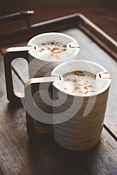 Close-up of two cups of cappuccino
