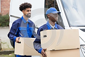 Two Men Holding The Cardboard Boxes photo