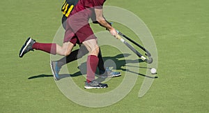 Close up of two field hockey players, challenging eachother for the control and posession of the ball during an intense,