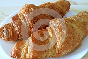 Close-up of Two Fresh Whole Wheat Croissant Pastries Served on White Plate