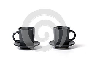 Close-up of two identical coffee tea cups with a saucer on a white background
