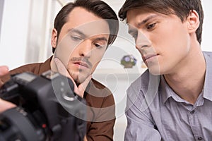 Close up of two men looking at the camera. photo