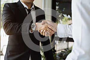 Close up two men shake hands at office negotiations. Making deal sign, conclude contract, formal greeting, Successful negotiations