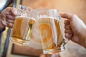 two men toasting with beer