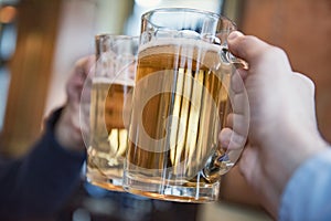 two men toasting with beer