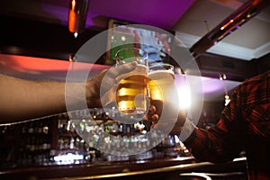 Close-up of two men toasting with beer