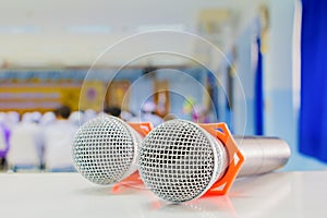 Close up two microphone wireless on the table in the conference and Background blur interior seminar meeting room