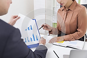 Close up of two office employees working with a diagram