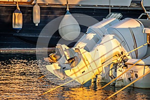 Close up of two outboard  boat engines in Alghero harbor at sunset