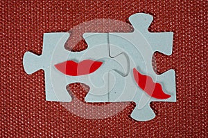 Close-up of two parts of puzzle. Symbolic women with lips. The concept of psychological compatibility, friendship.