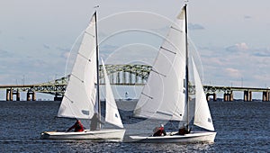 Two small sailboats with the Great South Bay bridge in background during December regatta