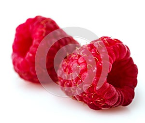 Close-up Two raspberry berries on a white background.