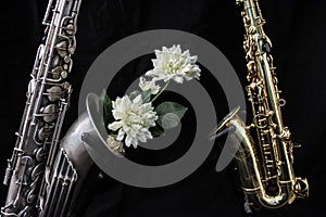 Close up of two saxophones decorated with flowers