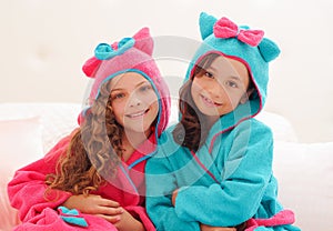 Close up of two sister wearing a bathtowel with hood