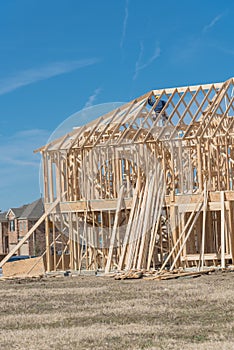 Close-up two-story stick built home with building contractor car