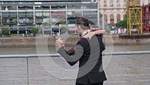 Close up of two tango dancers dancing with romantic moves in Puerto Madero docks
