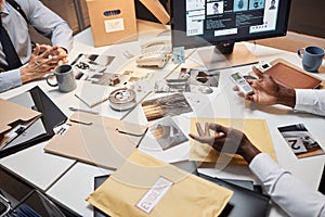 Close up of two unrecognizable detectives discussing case in office