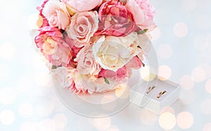 Close up of two wedding rings and flower bunch