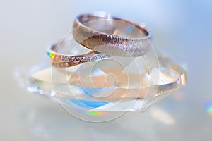 Close-up of two wedding rings with a reflexion.