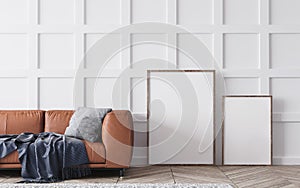 Close up for two wooden empty frames and orange leather sofa. Scandinavian living room, home decor