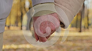 Close up two wrinkled hands elderly couple hold arms together romantic gesture old middle-aged family grandparents