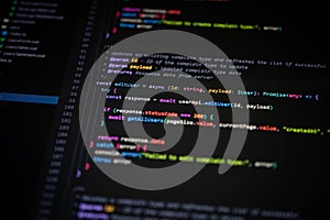 Close-up of TypeScript code editing user data with async functions on a dark IDE. Suitable for modern web development, software