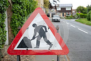 Close-up of a typical Roadworks sign seen located on a pavement area