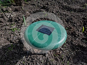 Close-up of the ultrasonic, solar-powered mole repellent or repeller device in the soil in a vegetable bed in the garden