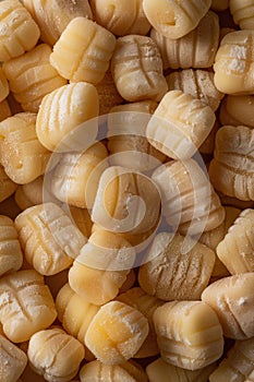 Close-up of uncooked gnocchi pasta on a wooden surface