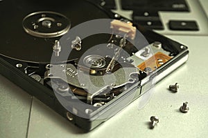 Close up of uncovered broken 2.5 inch hard drive with unreadable data.
