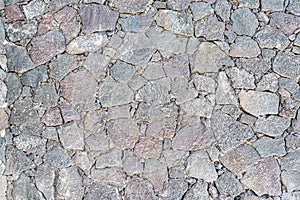 Close-up of uneven dry stone wall background