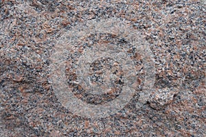 Closeup of uneven surface of pink granite stone