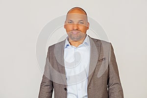 Close-up of unhappy african american businessman man in blazer curling his lips and looking at camera, upset about bad