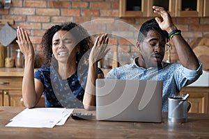 Close up unhappy African American couple frustrated by money problem