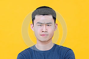 Close up of unhappy angry young Asian man face