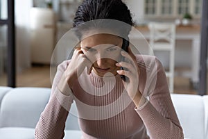 Close up unhappy woman talking on phone, hearing bad news