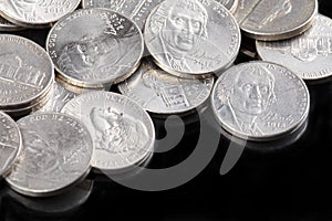 Close up of United States coins, Nickles on black background