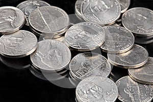 Close up of United States coins, Nickles on black background