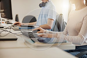 Close up of university student using computer studying in computer room