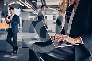 Close up of unrecognisable businesswoman working on laptop in office